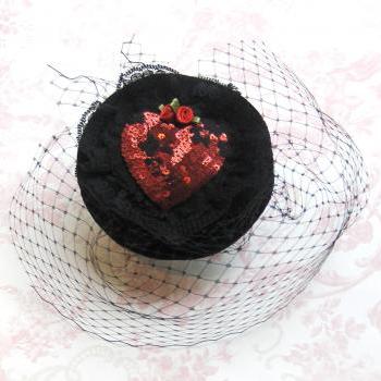 Ruby red heart cocktail hat.